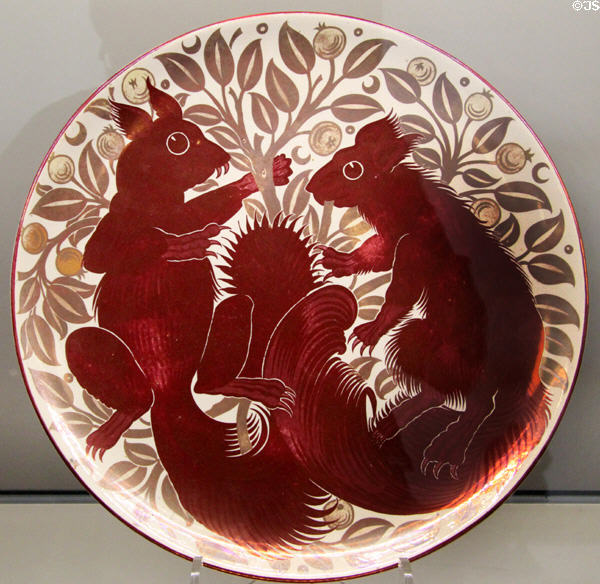 Ruby lustre plus gold squirrel plate (1888-1907) by William De Morgan for Sands End Pottery of Fulham at Ashmolean Museum. Oxford, England.