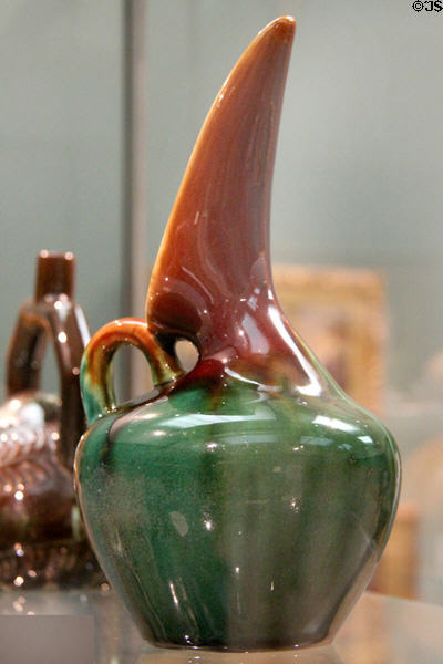 Earthenware beaked ewer (c1880) by Christopher Dresser made by Linthorpe Art Pottery at Ashmolean Museum. Oxford, England.