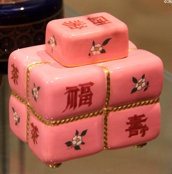 Porcelain tea caddy mimics tied bale which Chinese characters (c1880) by Christopher Dresser made by Minton & Co of Stoke-on-Trent at Ashmolean Museum. Oxford, England.
