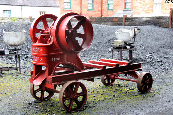 Stone crusher machine run by belt from steam engine made by Frederick Parker Viaduct Works of Leicester at Ulster Folk Park. Belfast, Northern Ireland.