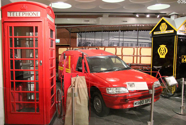 Electric Royal Mail Ford Ecostar van (1994) beside red telephone box & AA box at Ulster Transport Museum. Belfast, Northern Ireland.