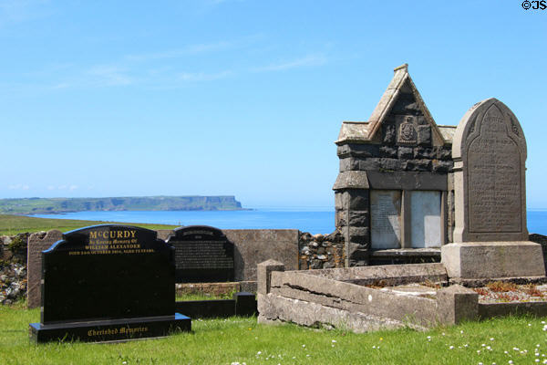 Gravestones & Antrim coast at Ballintoy Parish Church. Ballintoy, Northern Ireland.