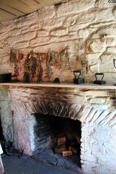 Fireplace in Pennsylvania Log Farmhouse at Ulster American Folk Park. Omagh, Northern Ireland.
