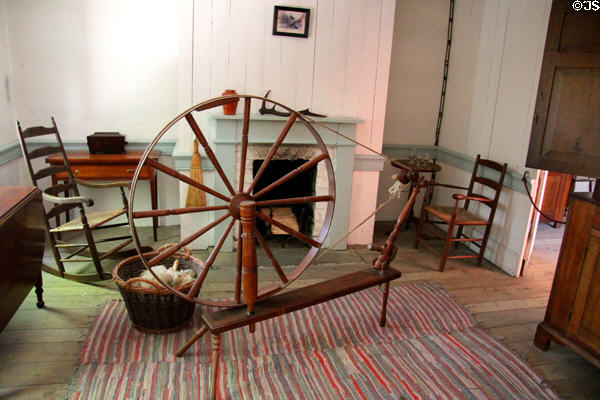 Spinning wheel & chairs in Pennsylvania Log Farmhouse at Ulster American Folk Park. Omagh, Northern Ireland.