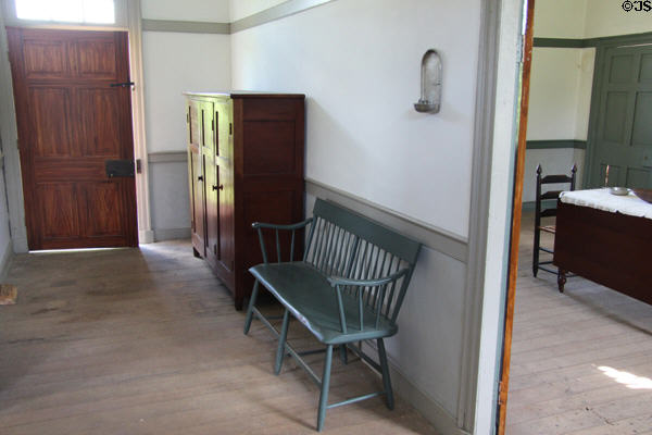 Hallway cabinet & bench in brick house at Ulster American Folk Park. Omagh, Northern Ireland.