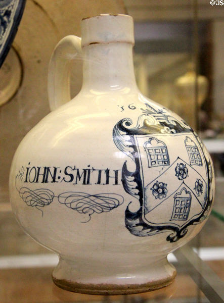 Tin-glazed earthenware wine bottle with arms of Pewterers' Co of London given as marriage gift to John Smith & Margeri (1650) from Southwark, London at British Museum. London, United Kingdom.