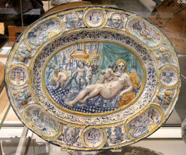 Tin-glazed earthenware oval dish with molded reliefs & painted with baroque scene (1659) from Southwark, London at British Museum. London, United Kingdom.