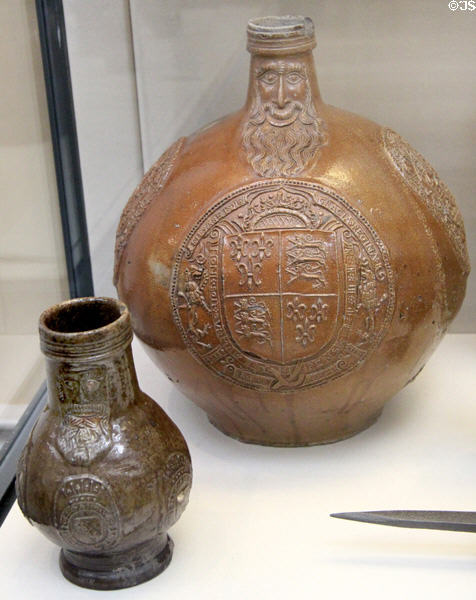 Stoneware Bartmann jugs: larger German version (1594) from Frechen, Rhineland & smaller English version (c1625-30) arms of Earl of Dorset made in Surrey-Hampshire at British Museum. London, United Kingdom.