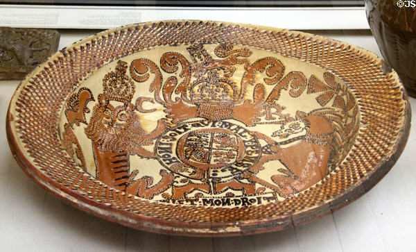 Earthenware slip glazed dish with arms of King Charles II (1670-80) by Thomas Toft of North Staffordshire at British Museum. London, United Kingdom.