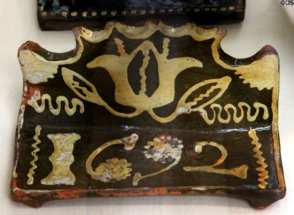 Earthenware slip glazed bacon roaster (1692) made in North Staffordshire at British Museum. London, United Kingdom.