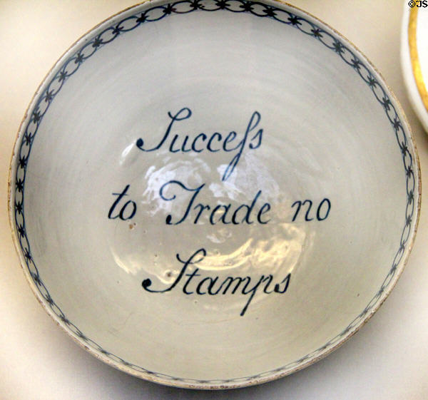 Tin-glazed earthenware bowl written 'Success to Trade / No Stamps' protesting British Stamp Act to raise funds for British troops sent to America (c1765) prob. from Bristol at British Museum. London, United Kingdom.