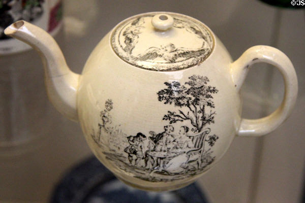 Creamware teapot transfer-printed with tea party scene (1770) by Thomas Radford for Derby Pot Works at British Museum. London, United Kingdom.