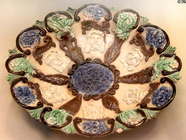 Glazed earthenware dish (1894) by Edward Bingham Junior for Castle Hedingham Pottery, Essex at British Museum. London, United Kingdom.