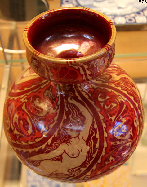 Earthenware red lustre vase with mermaids exhibited at Arts & Crafts Exhibit (1890) by Walter Crane & made by Maw & Co, Broseley, Shropshire at British Museum. London, United Kingdom.