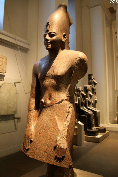 Red granite standing statue either king Tuthmosis III or Amenhotep II (18th Dynasty - c1450 BCE) from Karnak at British Museum. London, United Kingdom.