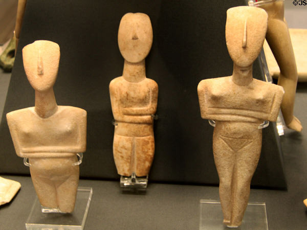 Cycladic marble female figures (flanking) Dokathismata-type (2500-2300 BCE) & (central) Spedos-type (2700-2500 BCE) all from Keros-Syros culture at British Museum. London, United Kingdom.