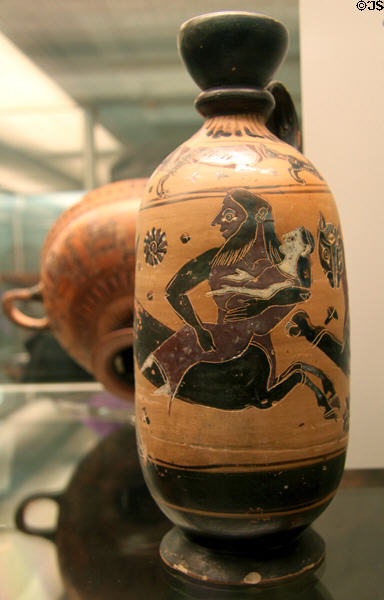 Greek terracotta black figure lekythos with centaur Nessos carrying off Deianeira (600-580 BCE) attrib. to Deianeira painter made in Athens found in Corinth at British Museum. London, United Kingdom.