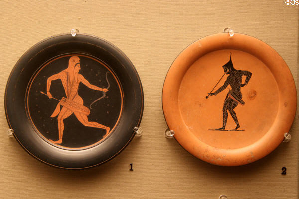Greek terracotta red figure & black figure plates with archers (c520-500 BCE) made in Athens by two painters (Epiktetos (l) & Psiax (r)) at British Museum. London, United Kingdom.
