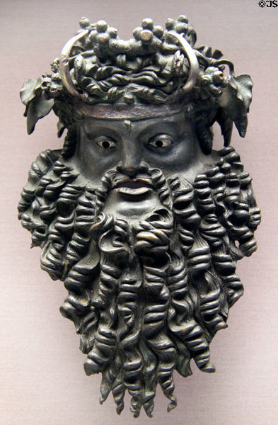 Bronze mask of horned Dionysus once handle for wine bucket (200-100 BCE) at British Museum. London, United Kingdom.