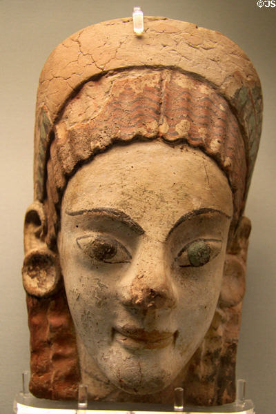 Etruscan painted terracotta antefix molded with head of woman wearing disk earrings (520-200 BCE) from Cerveteri at British Museum. London, United Kingdom.