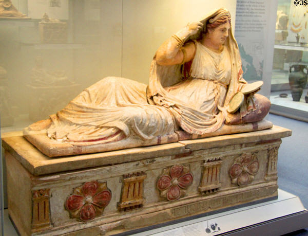 Etruscan carved terracotta cinerary urn with reclining woman with open lidded mirror on lid & columns & flowers on chest (150-130 BCE) from near Chiusi at British Museum. London, United Kingdom.
