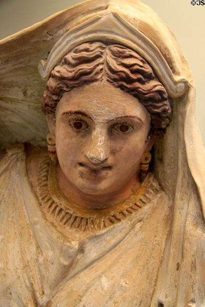 Detail of face of reclining woman on Etruscan carved terracotta cinerary urn (150-130 BCE) from near Chiusi at British Museum. London, United Kingdom.