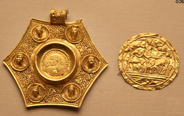 Roman gold pendant with Constantine I ringed by six busts plus sheet metal medallion with emperor in a chariot (4thC CE) at British Museum. London, United Kingdom.