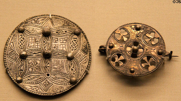 Anglo-Saxon silver sheet disc brooch with Trewhiddle-style decoration plus openwork brooch both (late 9thC) from Beeston Tor Hoard at British Museum. London, United Kingdom.