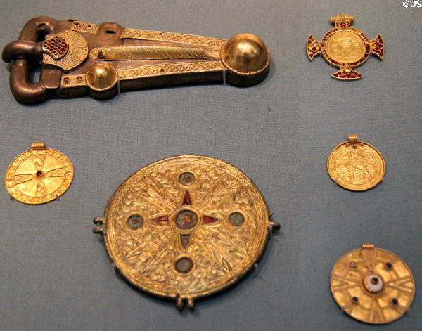 Anglo-Saxon metallic buckle & brooches showing transition to Christianity (600s) several from Kent, England at British Museum. London, United Kingdom.