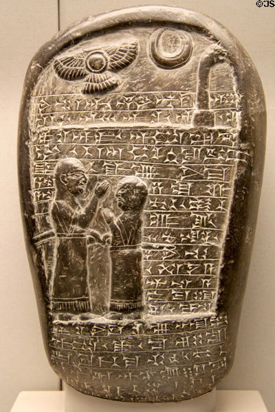 Stone monument with relief of father & son in cuneiform inscription (c900-800 BCE) from Marduk temple in Babylon now Iraq at British Museum. London, United Kingdom.