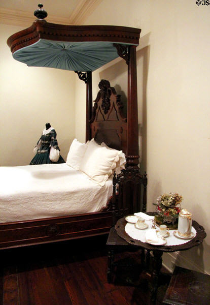 Half canopy bed & side table with porcelain coffee service at Bragg-Mitchell Mansion. Mobile, AL.
