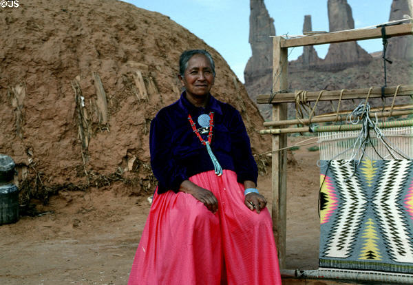 Native woman weaving Navajo rug. AZ.