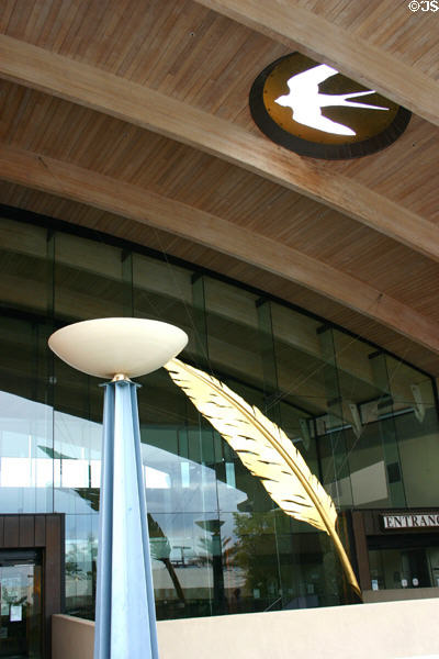 Civic Center Library entrance with floating quill & native symbol. Scottsdale, AZ.