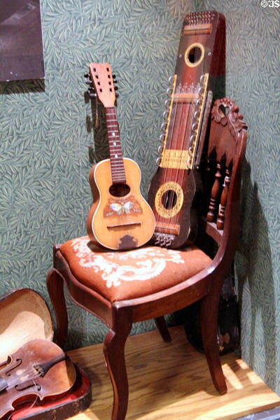 Stringed instruments on side chair at Arizona Historical Society Museum Downtown. Tucson, AZ.