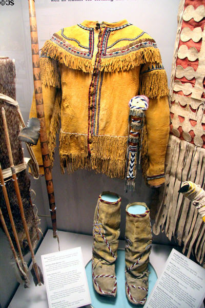Apache native beaded buckskin shirt (c1850), moccasins (c1935) with bow & arrows (1930s) at Arizona State Museum. Tucson, AZ.