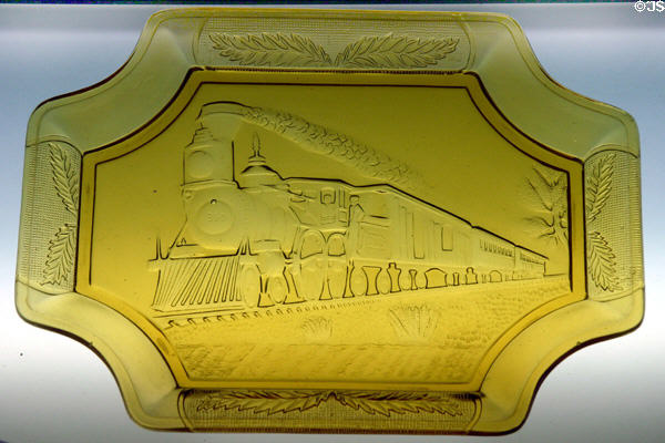 Yellow pressed glass commemorative tray with steam train at California State Railroad Museum. Sacramento, CA.