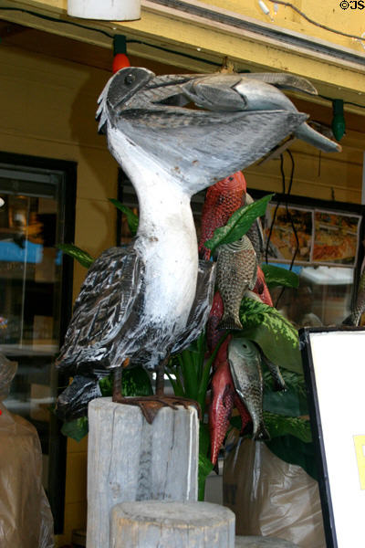 Carved pelican with fish on fisherman's wharf. Monterey, CA.