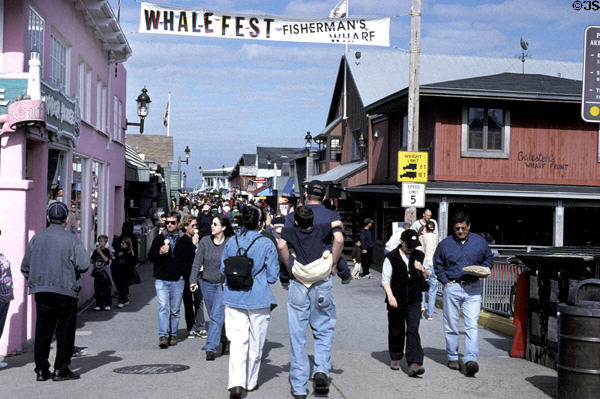 People stroll on fisherman's wharf. Monterey, CA.
