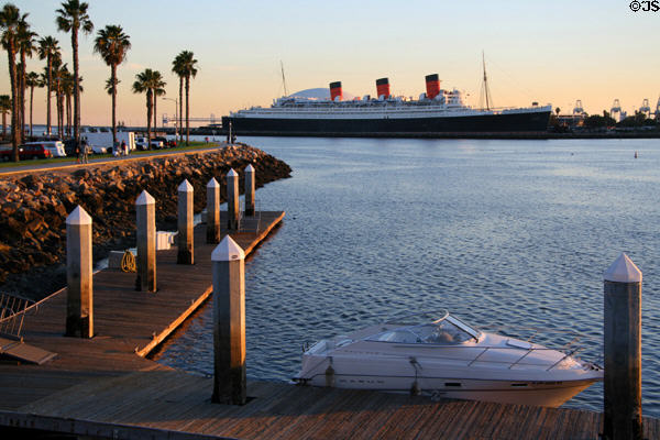 Queen Mary in light of sunset from Long Beach park. Long Beach, CA.