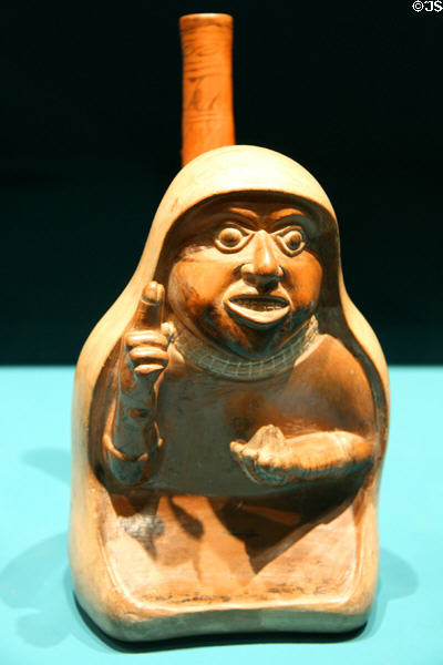 Lambayeque hooded person ceramic stirrup spout bottle (900-1430) from Peru at Fowler Museum. Los Angeles, CA.