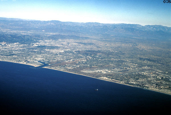 Los Angeles International Airport from air on coast at right with boomerang shaped inlet of Marina Del Rey to left. CA.