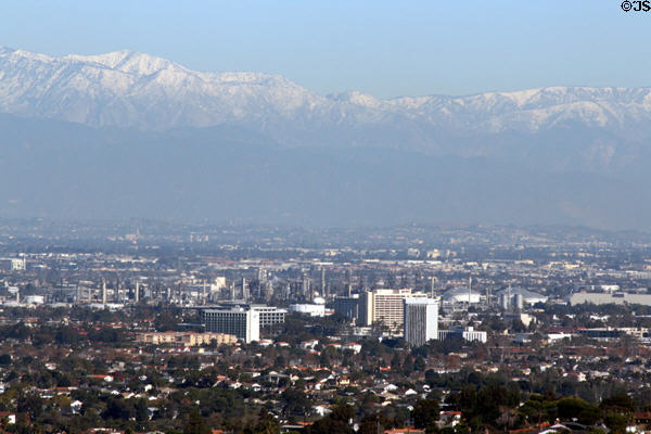 Skyline of Torrance & Mobil refinery area of Los Angeles against San Gabriel Mountains from Rancho Palos Verdes. Los Angeles, CA.
