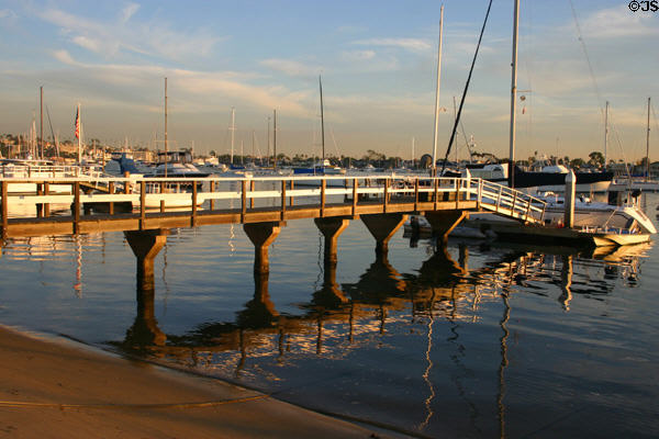 Boat dock reflected on water in channel off Balboa Island. CA.