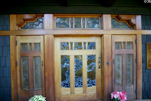 Gamble house front door with leaded glass window of tree. Pasadena, CA.