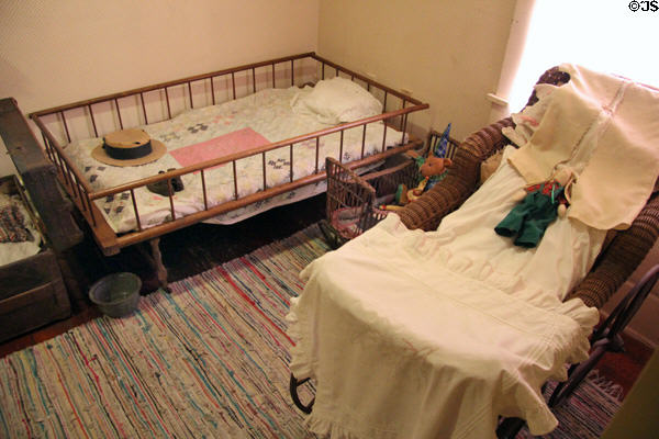 Infant's bed & wicker carriage at Davis House Museum. San Diego, CA.
