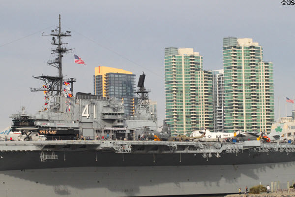 Midway aircraft carrier museum from harbor against city skyline. San Diego, CA.