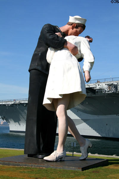 Unconditional Surrender giant sculpture of sailor kissing nurse on V-J day by Seward Johnson after famous photograph in park beside Midway carrier museum. San Diego, CA.