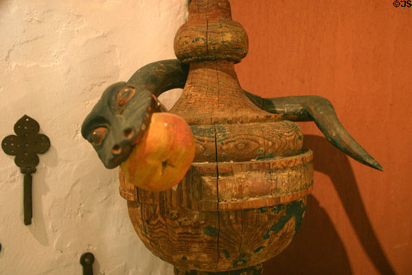 Carved finial with snake holding apple (1813) in Mission San Luis Rey. Oceanside, CA.