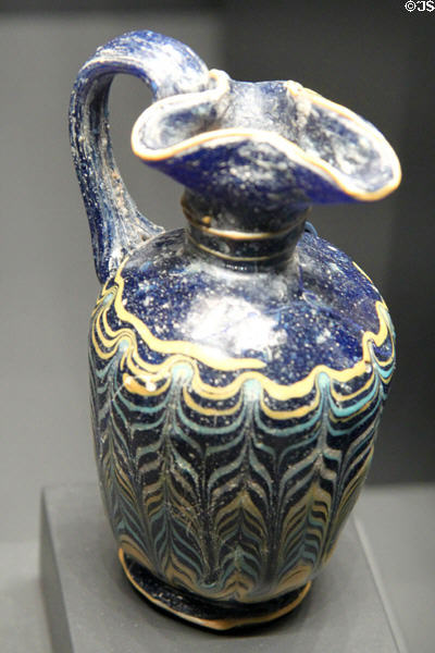 Greek or Etruscan blue glass pitcher (Oinochoe) with white, yellow & turquoise feathered decoration (400-200 BCE) at Getty Museum Villa. Malibu, CA.