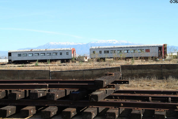 Rail cars against snow-capped mountains at Orange Empire Railway Museum. Perris, CA.